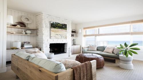 a living room with a couch and a fireplace at Beachfront at Avoca North in North Avoca