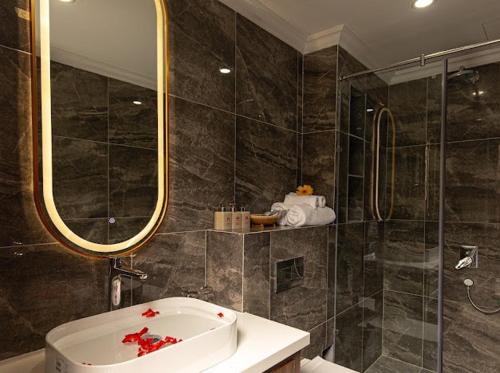 a bathroom with a tub and a sink and a shower at Simon House Hoi An in Hoi An