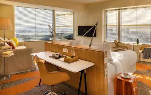 a bedroom with a white bed and a desk and a keyboard at Too Hotel & Spa Paris - MGallery Collection in Paris