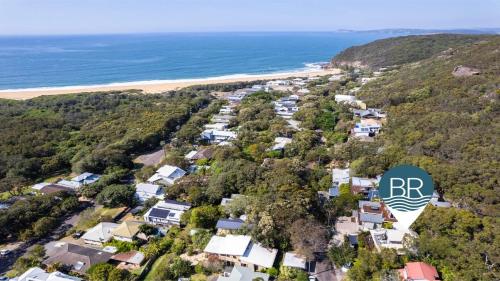 A bird's-eye view of Bush and Bay Setting With Easy Walk To Beach