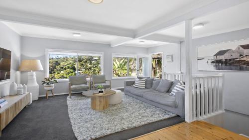 a living room with a couch and a table at Large family house with a pool and easy walk to beach and village in Copacabana