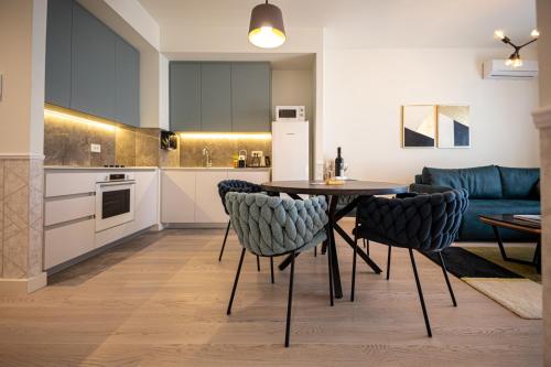 a kitchen and living room with a table and chairs at Apartments Royal - Belgrade Waterfront in Belgrade