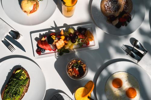 a white table with plates of food on it at W Dubai - The Palm in Dubai