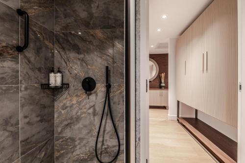 a bathroom with a shower with a glass door at Magnes Hotel in Volos