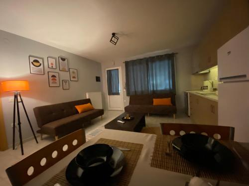 a living room with a couch and a table at Cozy house in Xanthi
