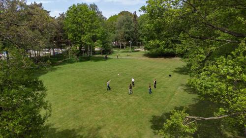 a group of people standing in a grass field at 50|50 Hotel Belmont in Ede