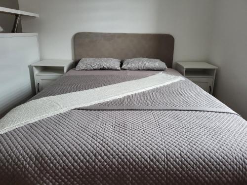 a bed with two pillows on it in a bedroom at Stara Pošta Apartment 5 in Grosuplje