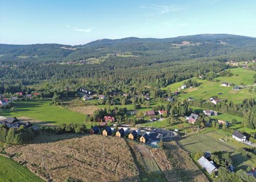 an aerial view of a village in the mountains at Słoneczne Wzgórze in Koniaków