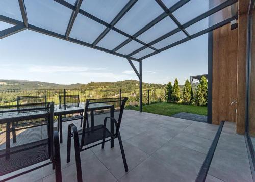 a screened in porch with a view of the mountains at Słoneczne Wzgórze in Koniaków