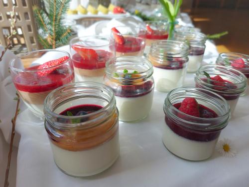 a group of desserts in mason jars on a table at Pohorje Village Wellbeing Resort - Forest Apartments Videc in Pohorje