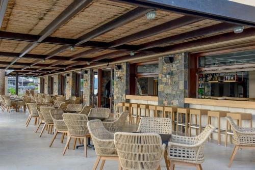 a row of chairs and tables on a patio at Blue Sea Beach Affiliated By Melia in Stalida