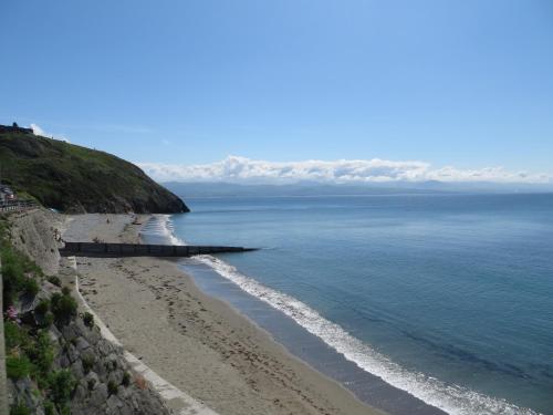 uma vista para a praia e para o oceano em Glan y Mor, Sleeps 20, 8 Bedrooms, 8 Bathrooms, Seafront, Criccieth em Criccieth