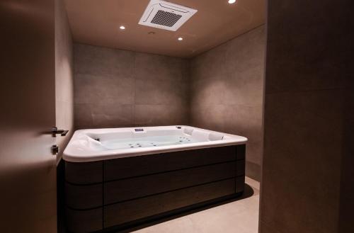 a bathroom with a bath tub in a room at Magnes Hotel in Volos