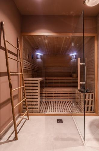 a sauna with a ladder in a room at Magnes Hotel in Volos