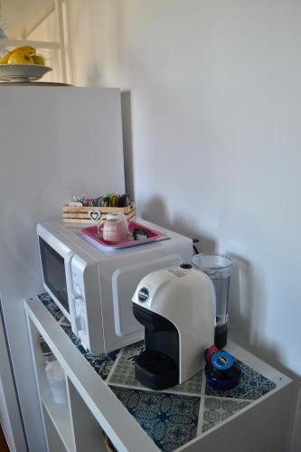 a toaster sitting on a counter next to a microwave at In campagna in Besozzo