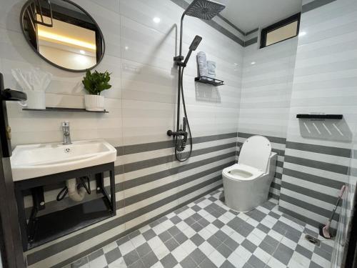 a bathroom with a sink and a toilet at Funhome Apartment Kim Ma Ha Noi in Hanoi