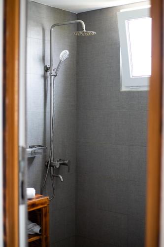 a bathroom with a shower with a shower head at Dhiffushi Inn in Dhiffushi