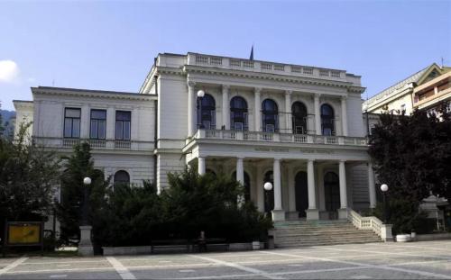 a large white building with a staircase in front of it at TIM Apartment Sarajevo with private Parking in Sarajevo