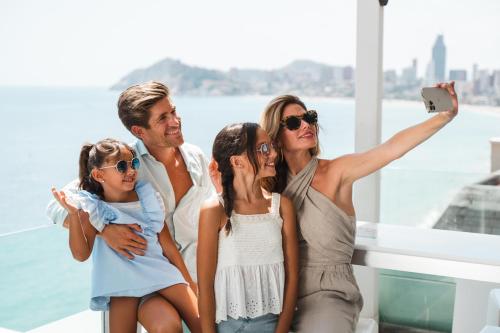 a family taking a picture on a cruise ship at Hotel Villa del Mar in Benidorm