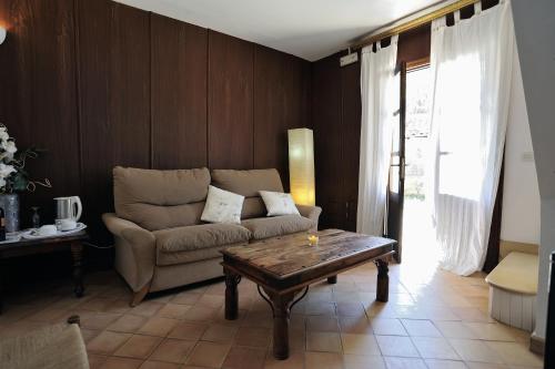 a living room with a couch and a coffee table at Petit Hotel Es Figueral in Campos