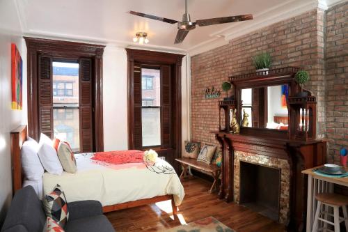 a bedroom with a bed and a fireplace at The Harlem Getaway in New York