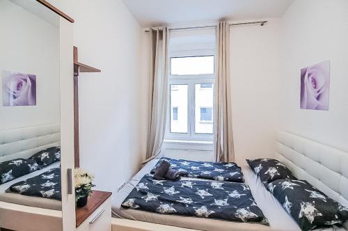 a small bedroom with a bed and a window at Premier Double room TH in Vienna