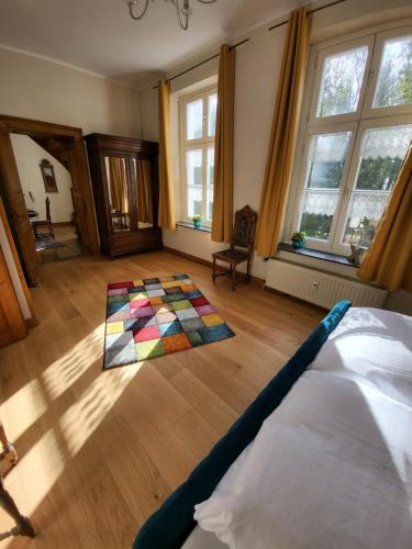 a bedroom with a colorful rug on the floor at Haus Husen in Xanten