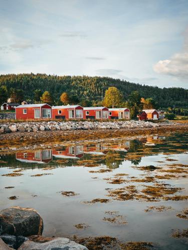 a group of houses sitting next to a body of water at Norwegian Wild in Vangsvik