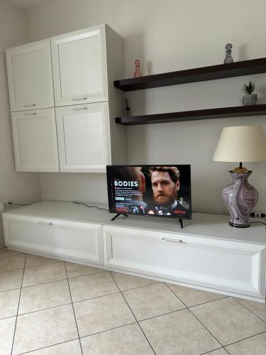 a white cabinet with a tv on top of it at Val di Non Apartment in Cles