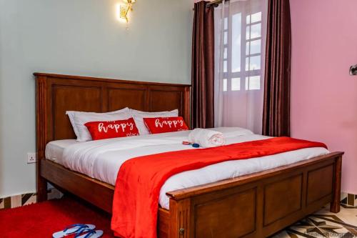 a bedroom with a bed with a red blanket at One Bedroom Roysambu Mirema Drive in Nairobi