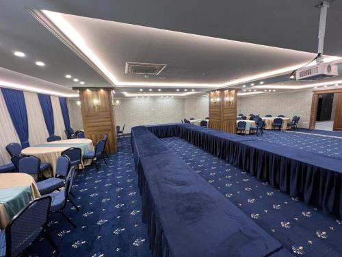 a banquet hall with tables and chairs in a room at Hotel Classy Stay in Erbil