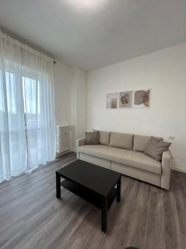 a living room with a couch and a coffee table at Exphome in Novate Milanese