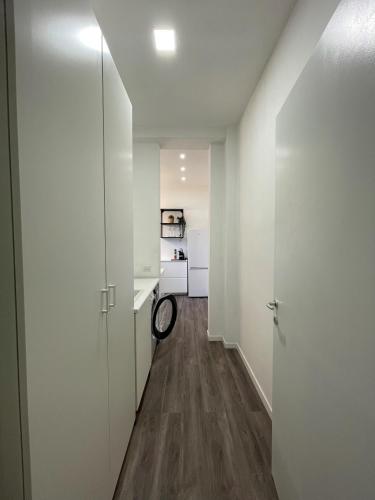 a hallway with white walls and a hard wood floor at Exphome in Novate Milanese
