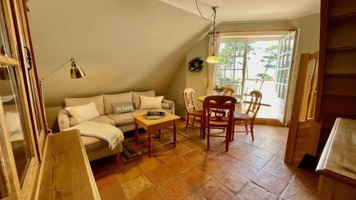 a living room with a couch and a table at Haus Strandgut FW 4 in Ahrenshoop