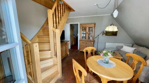 a dining room with a wooden table and chairs at Haus Strandgut FW 4 in Ahrenshoop