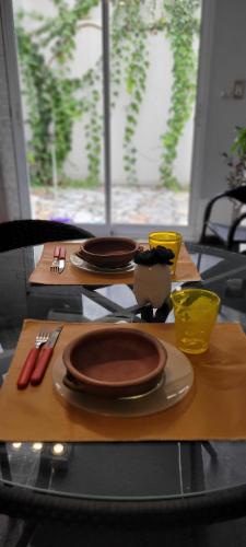 a table with plates and utensils on top of it at PERFECTO ESPACIO in Santiago del Estero