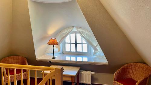 a room with a window with a table and chairs at Haus Strandgut FW 6 in Ahrenshoop
