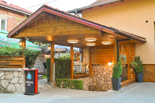 a building with awning on the side of it at Hotel Rothmans-Breakfast - Free parking - Lobby in Bansko
