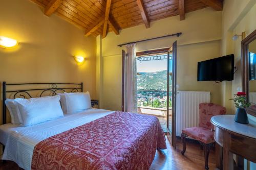 a bedroom with a bed and a tv and a window at Finday Eco Boutique Hotel in Kalavrita