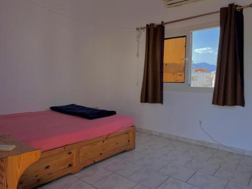 a bedroom with a bed and a window in a room at Nook in Dahab