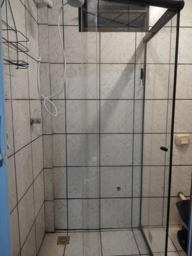 a shower with a glass door in a bathroom at Quarto aconchegante Completo in Rio Branco