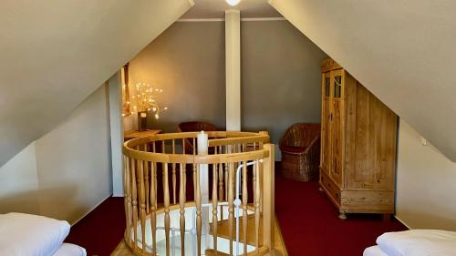 a room with a spiral staircase in a house at Haus Strandgut FW 5 in Ahrenshoop