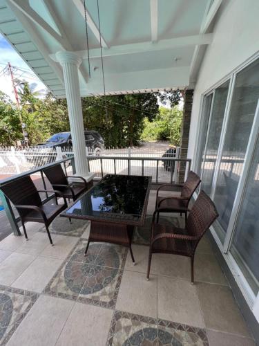a porch with chairs and a table on a porch at Grande Villa in Panglao