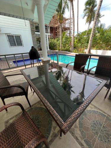 a porch with chairs and a swimming pool at Grande Villa in Panglao