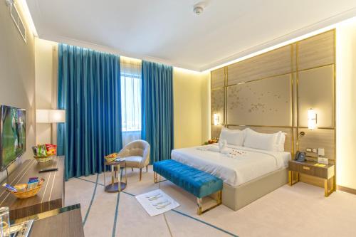 a hotel room with a bed and a chair at Green Park Hotel in Doha