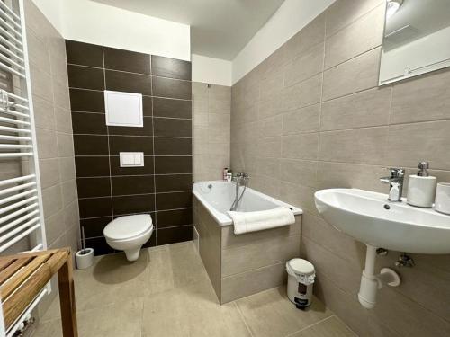 a bathroom with a sink and a toilet and a sink at Sky apartments 504 in Plzeň