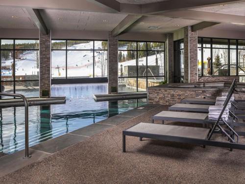 a swimming pool with a row of benches in a building at Suite residence at Grand Colorado on Peak 8 in Breckenridge