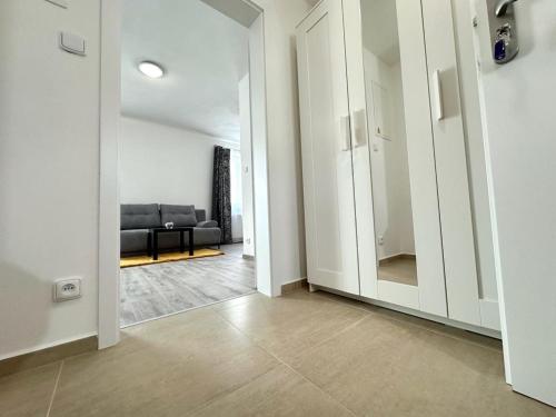 a hallway with a living room with a couch at Sky apartments 504 in Plzeň