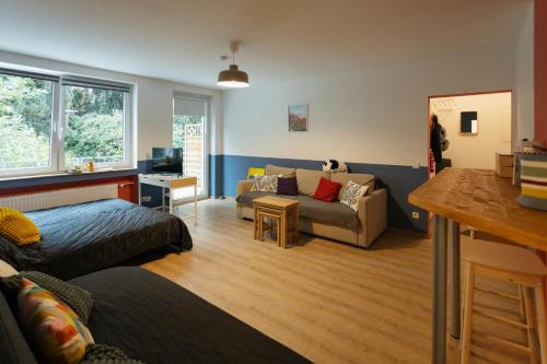 a living room with a couch and a living room with at Central apartment with Terrace and a free parking in Duisburg