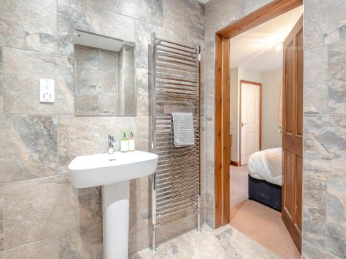 a bathroom with a sink and a shower at Walnut Cottage - Uk45579 in Maltby le Marsh